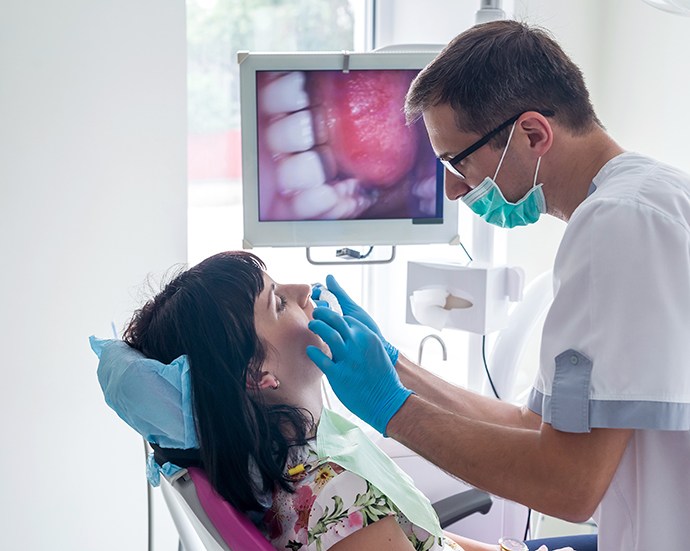 a dentist examining a patient’s mouth