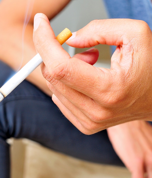 a man holding a cigarette